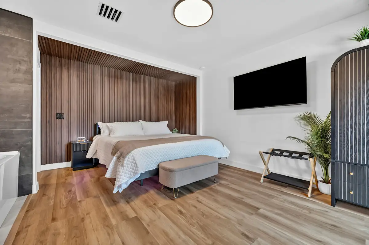 Elara primary bedroom with wood accent wall